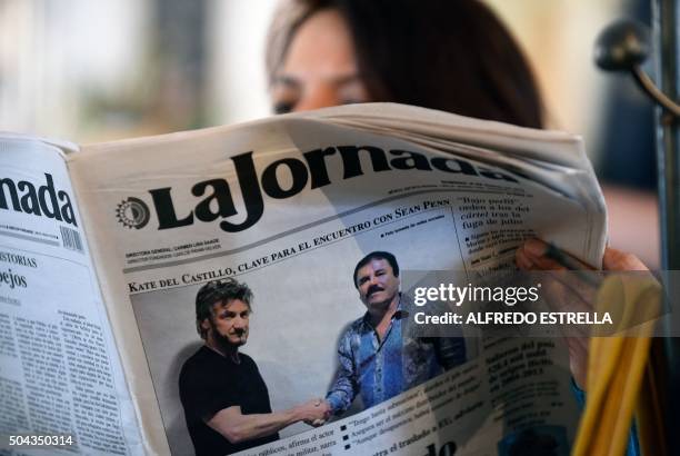 Woman reads La Jornada newspaper in Mexico City, on January 10, 2016 which shows a picture of drug lord Joaquin Guzman, aka "El Chapo" , shaking...