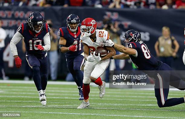 Marcus Peters of the Kansas City Chiefs intercepts a pass as Ryan Griffin of the Houston Texans along with DeAndre Hopkins and Jonathan Grimes...