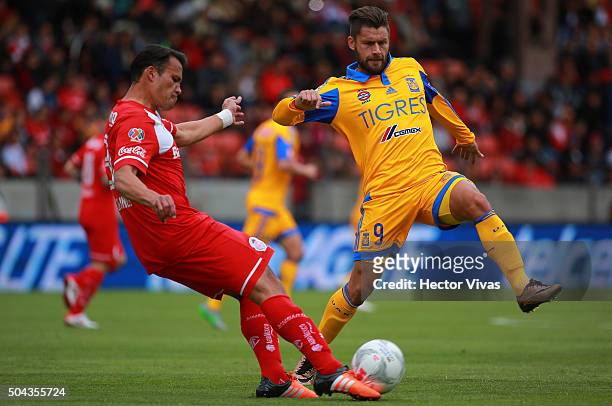 Aaron Galindo of Toluca struggles for the ball with Rafael Sobis of Tigres during the 1st round match between Toluca and Tigres UANL as part of the...