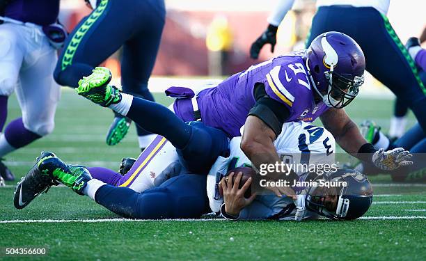 Everson Griffen of the Minnesota Vikings sacks Russell Wilson of the Seattle Seahawks in the third quarter during the NFC Wild Card Playoff game at...