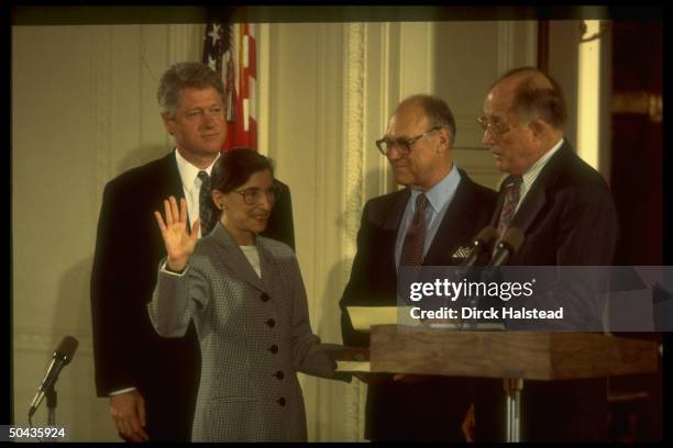 Supreme Court Chief Justice William Rehnquist swearing in new justice Ruth Bader Ginsburg as husband Martin & Pres. Bill Clinton look on.