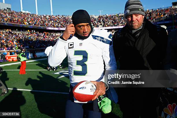 Russell Wilson of the Seattle Seahawks walks off the field after defeating the Minnesota Vikings with a score of 10 to 9 during the NFC Wild Card...