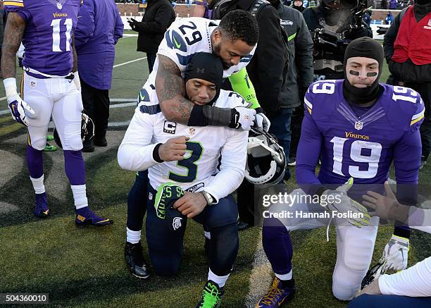 Earl Thomas of the Seattle Seahawks and Russell Wilson react after defeating the Minnesota Vikings with a score of 10 to 9 during the NFC Wild Card...