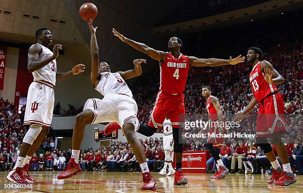 Troy Williams of the Indiana Hoosiers shoots an off-balance shot as Daniel Giddens of the Ohio State Buckeyes defends at Assembly Hall on January 10,...