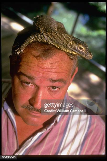 Zoo keeper Johnny Arnett w. Komodo dragon perched atop his head at Cincinnati Zoo.