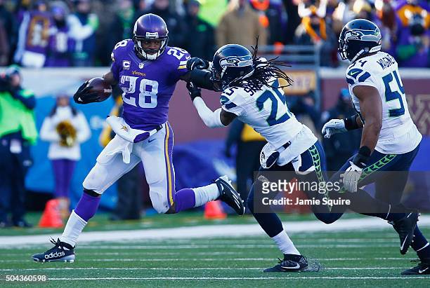Adrian Peterson of the Minnesota Vikings stiff arms Richard Sherman of the Seattle Seahawks in the second half during the NFC Wild Card Playoff game...