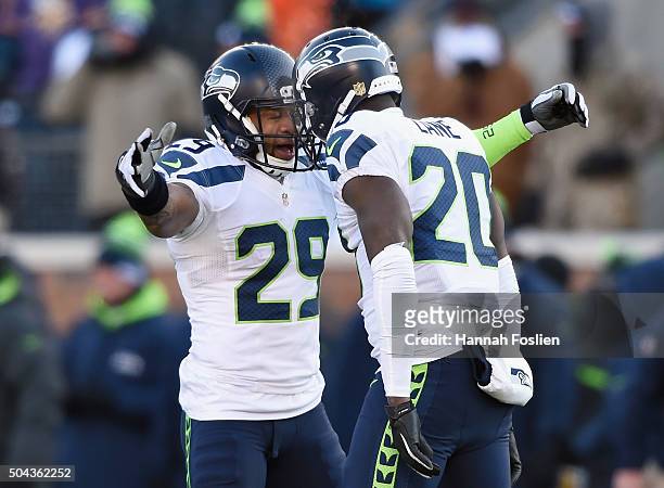 Earl Thomas of the Seattle Seahawks and Jeremy Lane celebrate after Lane broke up a pass in the fourth quarter against the Minnesota Vikings during...