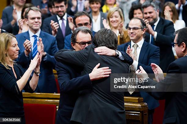 Former President of Catalonia Artur Mas congratulates Carles Puigdemont after he was elected new President of Catalonia during the parliamentary...