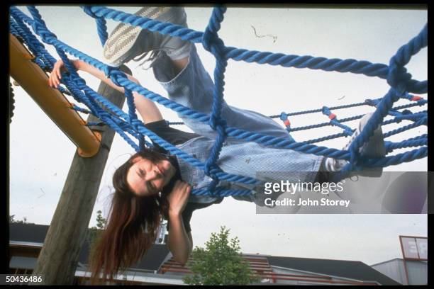 Yr-old actress Claire Danes romping on rope jungle gym.