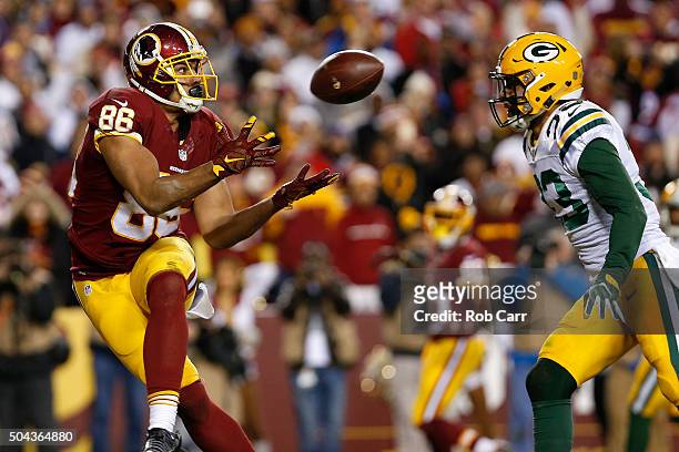 Tight end Jordan Reed of the Washington Redskins scores a second quarter touchdown past strong safety Micah Hyde of the Green Bay Packers during the...