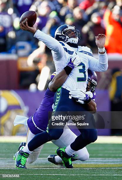 Everson Griffen of the Minnesota Vikings attempts to tackle Russell Wilson of the Seattle Seahawks in the fourth quarter during the NFC Wild Card...
