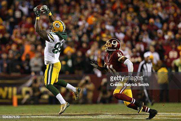 Wide receiver James Jones of the Green Bay Packers catches the ball while cornerback Will Blackmon of the Washington Redskins defends in the second...