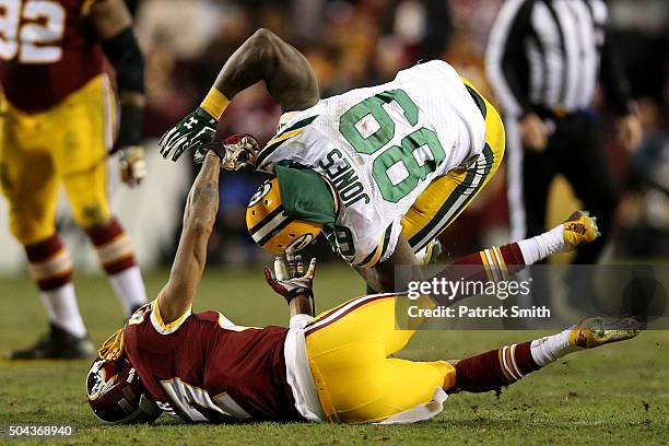 Wide receiver James Jones of the Green Bay Packers is tackled by cornerback Quinton Dunbar of the Washington Redskins in the second quarter during...