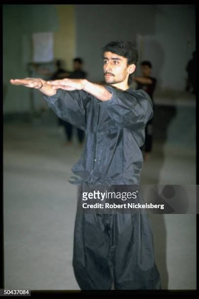 Young man poised in Tae Kwan Do movement, working out at club in Kandahar, Afghanistan.