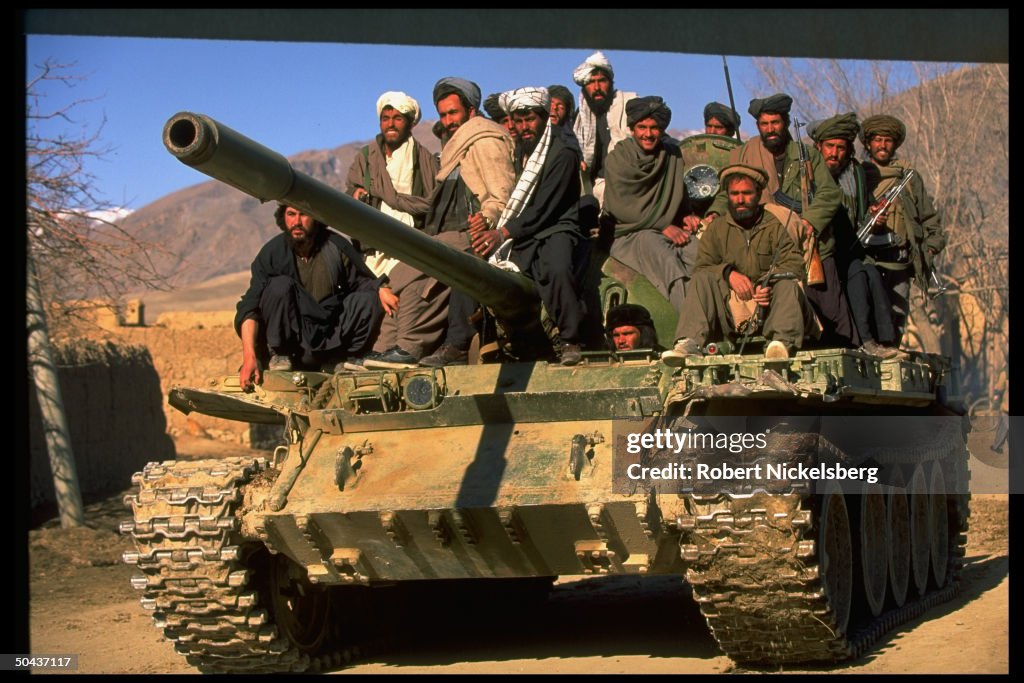 Taliban fighters w. tank at HQ taken fr.