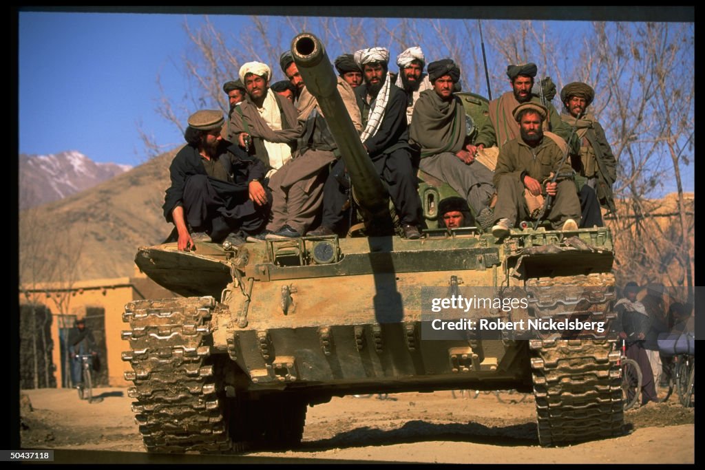 Taliban fighters w. tank at HQ taken fr.