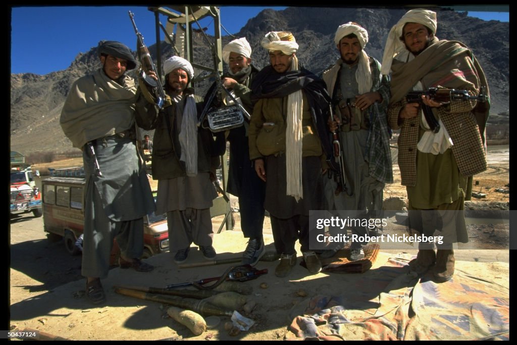 Taliban fighters at checkpoint on road l