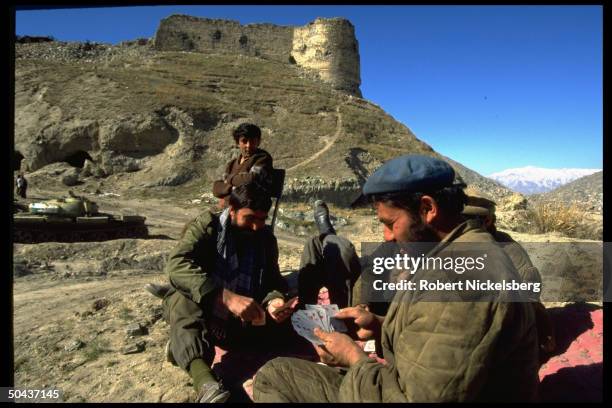 Rabbani govt. Soldiers playing cards at fort garrison above city, calm w. Rout of Hekmatyar mujahedin by dominant civil war Taliban faction.