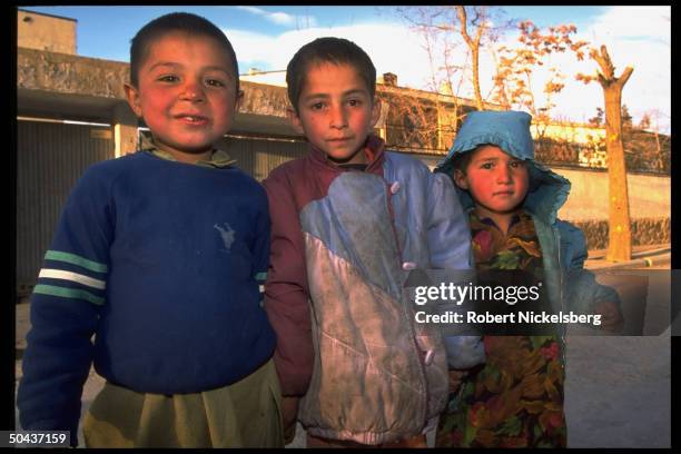 Trio of children out on street in civil war lull afforded by rout of city-sieging Hekmatyar mujahedin by Taliban faction, prob. In govt-held Kabul.