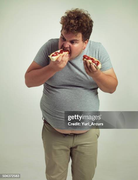 perfect food for a day at the game - man eating hot dog stock pictures, royalty-free photos & images