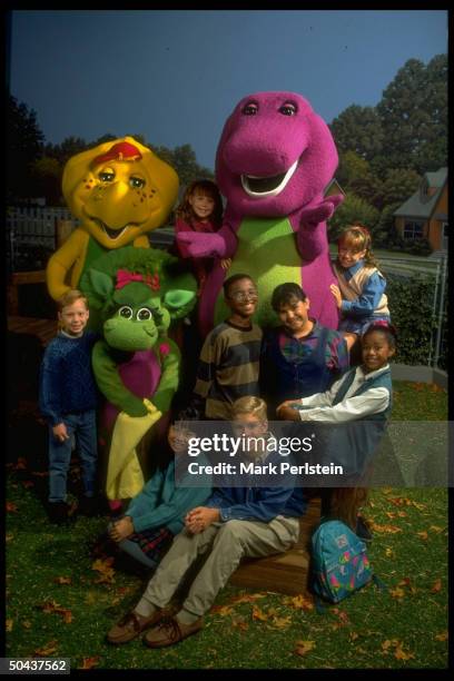 Barney, the purple dinosaur, dominating scene fr. PBS TV series Barney & Friends.