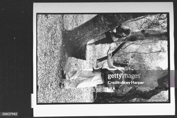 Holocaust survivor Zev Kedem aka Zbigniew Wohlfeiler holding son Adam while daughter Katia climbs tree in park; he was at Oskar Schindler's factory...