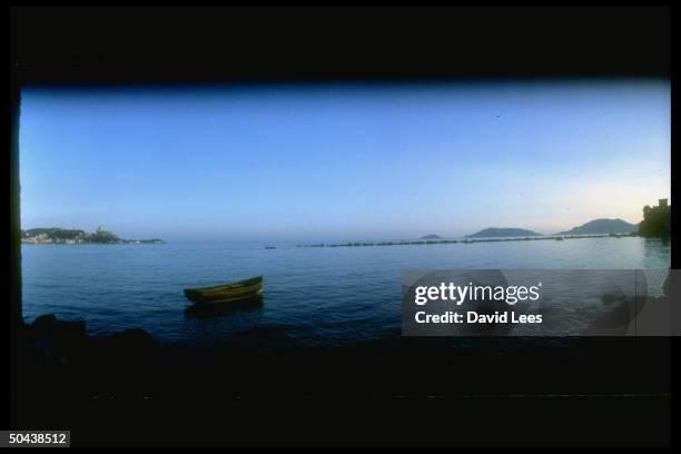 Small boat floating in the Bay of Lerici, opposite home of British poet Percy Bysshe Shelley, at dusk.