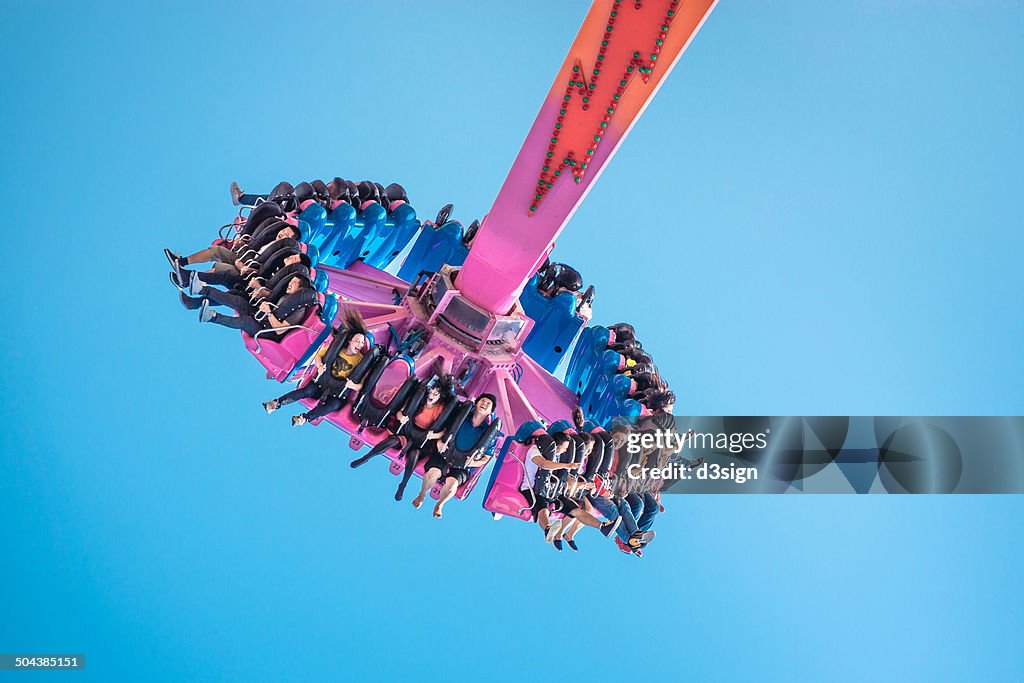 People having fun on The Flash in theme park