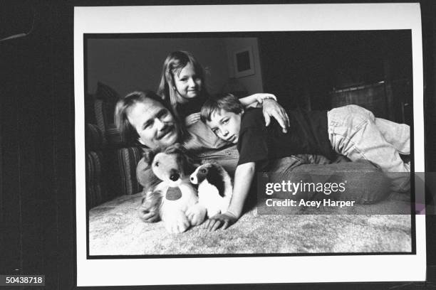 Former child actor Jon Provost from TV series Lassie, w. Daughter Katie & son Ryan lying on floor w. Lassie stuffed toy animals in living rm. At home.