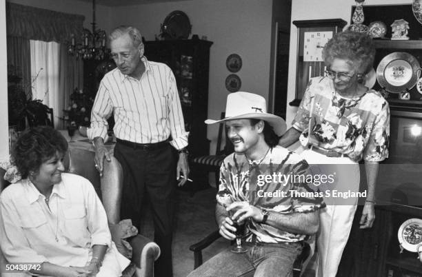 Musician Tim McGraw, son of baseball player Tug McGraw, clad in ever-present cowboy hat chatting w. Mother Betty Trimble , grandmother Catherine...