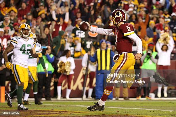 Quarterback Kirk Cousins of the Washington Redskins scores a third-quarter touchdown against strong safety Morgan Burnett of the Green Bay Packers...