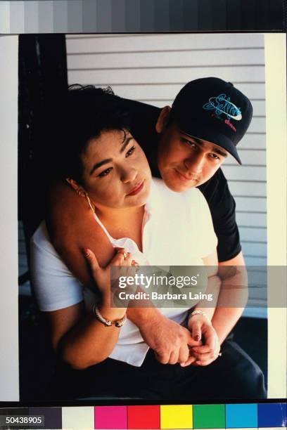 Chris Perez, husband of slain tejano singer Selena, posing w. Arms around her sister Suzette Quintanilla.