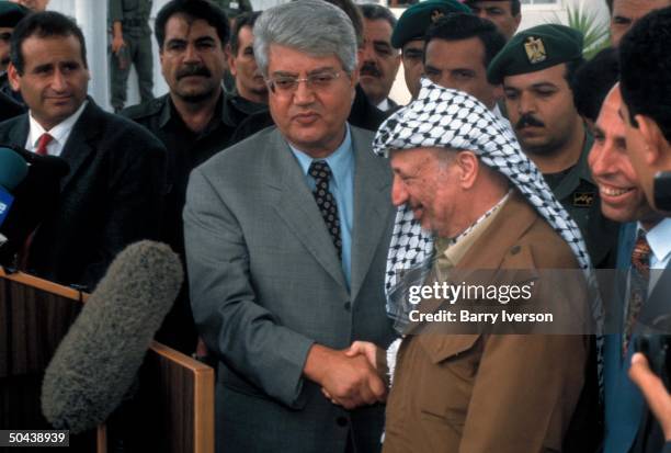 Israeli For. Min. David Levy shaking hands w. PLO ldr. Yasser Arafat, speaking to press in 1st official mtg. Between Likud-led govt. Rep & PLO ldr.,...