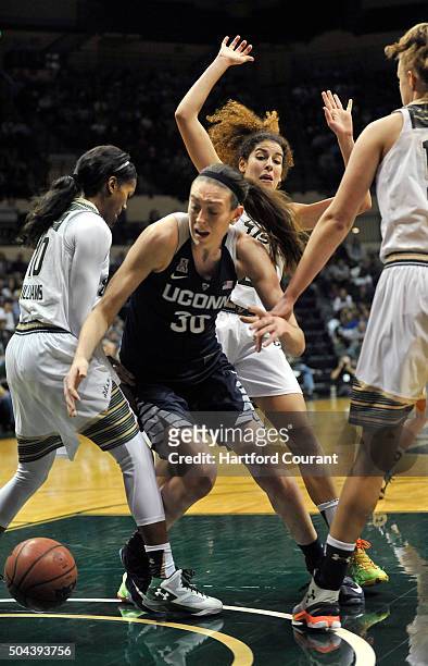 Connecticut's Breanna Stewart tries to grab a loose ball between South Florida's Courtney Williams and Paige Cashin at the USF Sun Dome in Tampa,...