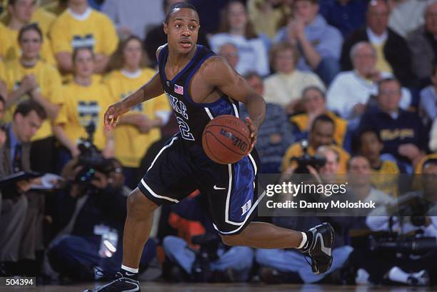 Point guard Jason Williams of the Duke Blue Devils dribbles the ball during the NCAA basketball game against the Michigan Wolverines at Crisler Arena...