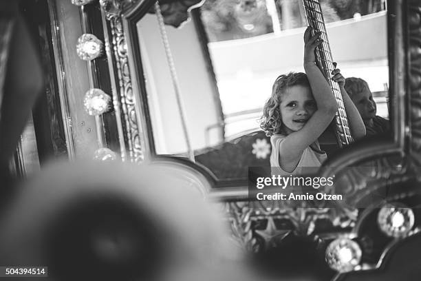 children's carousel reflection - girl in mirror stockfoto's en -beelden