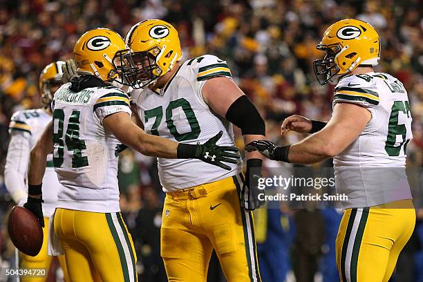 Wide receiver Jared Abbrederis of the Green Bay Packers celebrates with teammates guard T.J. Lang and center Corey Linsley of the Green Bay Packers...