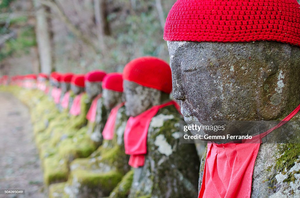 Japanese stone statues w/ red hat in Nikko, Japan