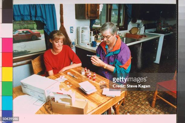 Primary pulmonary hypertension sufferer Connie Schweitzer watching father Rick prepare syringe of experimental drug prostacyclin, which gets...