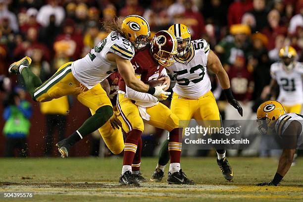 Quarterback Kirk Cousins of the Washington Redskins is sacked by inside linebacker Clay Matthews of the Green Bay Packers in the fourth quarter...