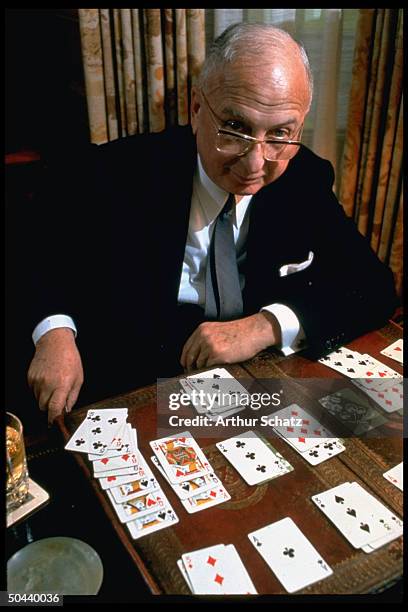 Seagrams founder Sam Bronfman playing game of solitaire.