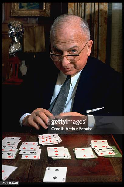 Seagrams founder Sam Bronfman playing game of solitaire.