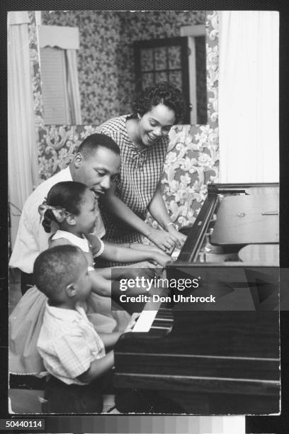 Civil Rights activist Rev. Dr. Martin Luther King Jr. With his wife Coretta, daughter Yolanda and Martin Luther III sitting together as they play...