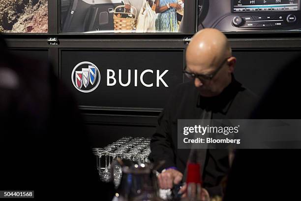 General Motors Co. Buick signage is displayed at a bar during an event ahead of the 2016 North American Auto Show in Detroit, Michigan, U.S., on...