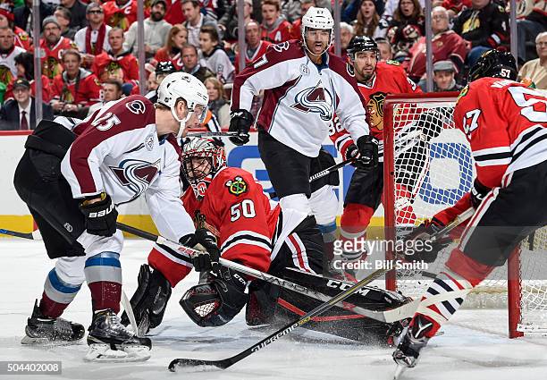 Goalie Corey Crawford of the Chicago Blackhawks is scored on as Mikhail Grigorenko of the Colorado Avalanche rushes in, and Andreas Martinsen and...