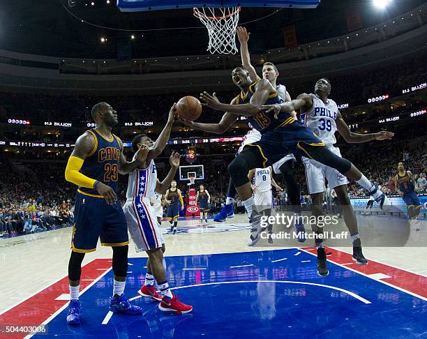 Tristan Thompson of the Cleveland Cavaliers attempts a shot over Ish Smith, Nik Stauskas, and Jerami Grant of the Philadelphia 76ers on January 10,...