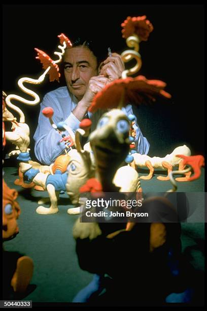 Children's book author/illustrator Theodor Seuss Geisel poses with models of some of the characters he has created.