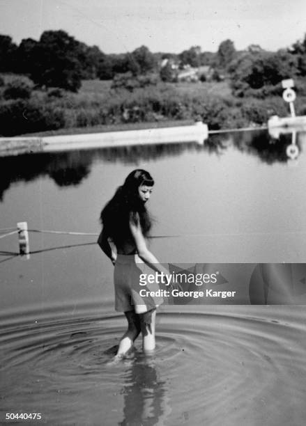 Anna May Wong walking into the lake.