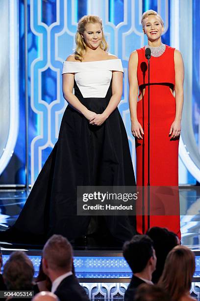 In this handout photo provided by NBCUniversal, Presenters Amy Schumer and Jennifer Lawrence speak onstage during the 73rd Annual Golden Globe Awards...