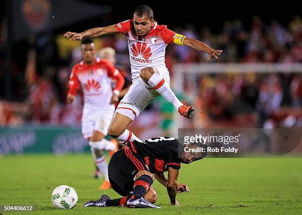 Sergio Otlvaro of the Indepediente Santa Fe jumps over Karim Bellarabi of the Bayer Leverkusen during the match at the ESPN Wide World of Sports...